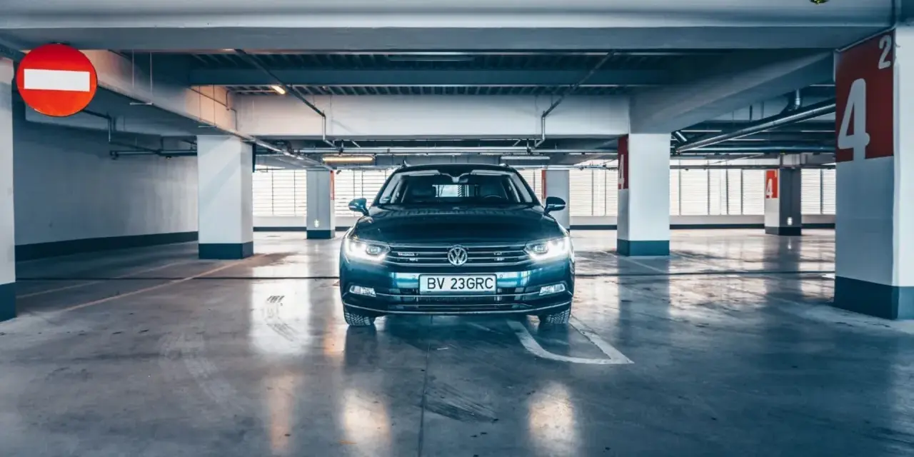 Voiture sombre garée dans un parking souterrain. La question est : combien de temps une voiture peut rester sans rouler avant de rencontrer des problèmes ?