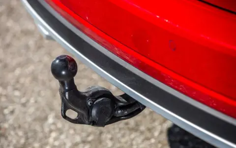 Boule d'attelage sur une voiture rouge, prête pour le remorquage.